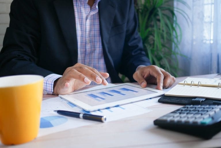 Small business owner reviewing financial reports to understand common accounting myths.